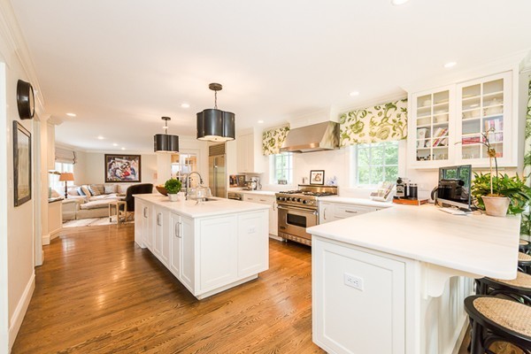 25 Forest Street Manchester, MA 01944 - Photo 8 of 24 a kitchen with stainless steel appliances kitchen island granite countertop a stove a sink and white cabinets with wooden floor