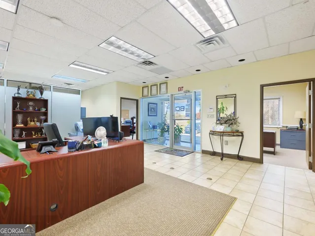 a very nice looking dining room with a large window and stainless steel appliances