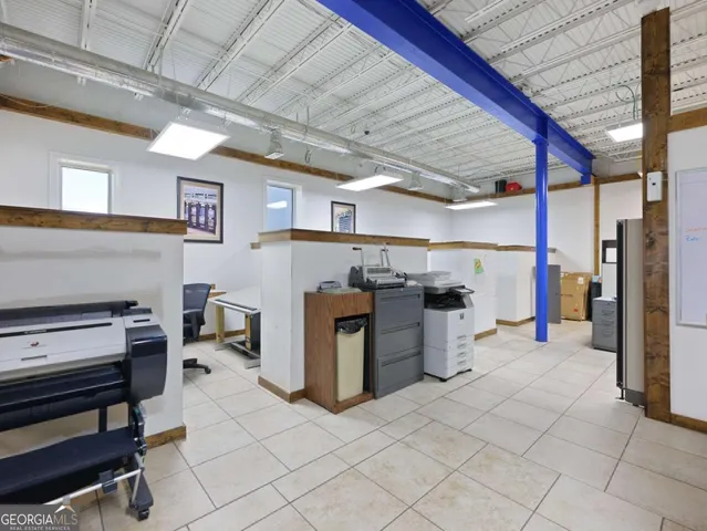 a view of a workspace with furniture and a window