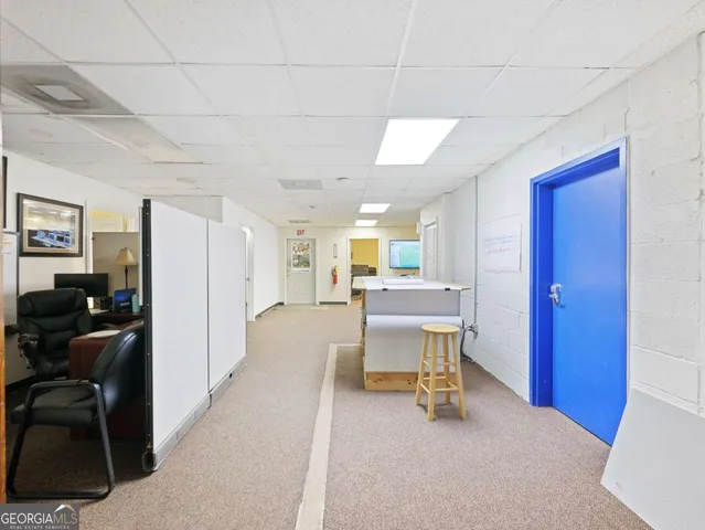 a view of a house with a yard and a large tree