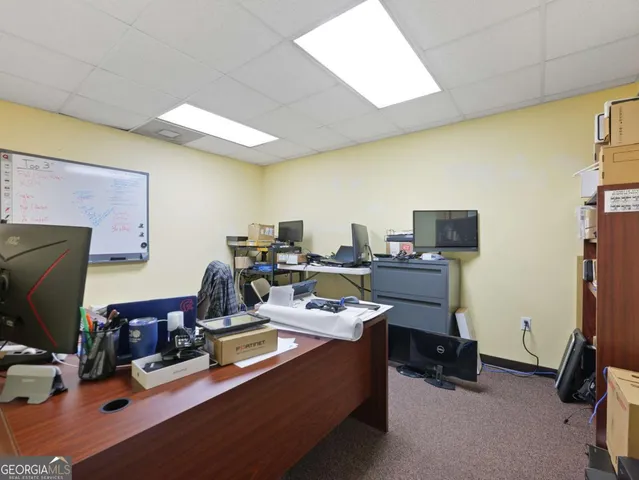 a view of a house with swimming pool and sitting area