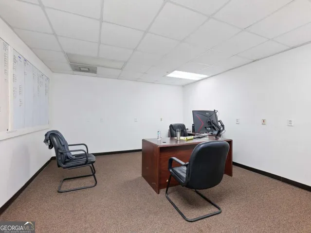a view of a house with backyard porch and sitting area