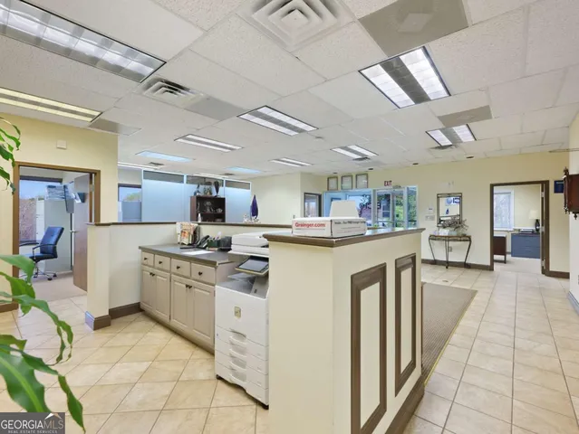 a view of a workspace with furniture and a window