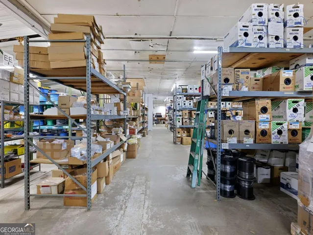 a view of a patio with table and chairs under an umbrella