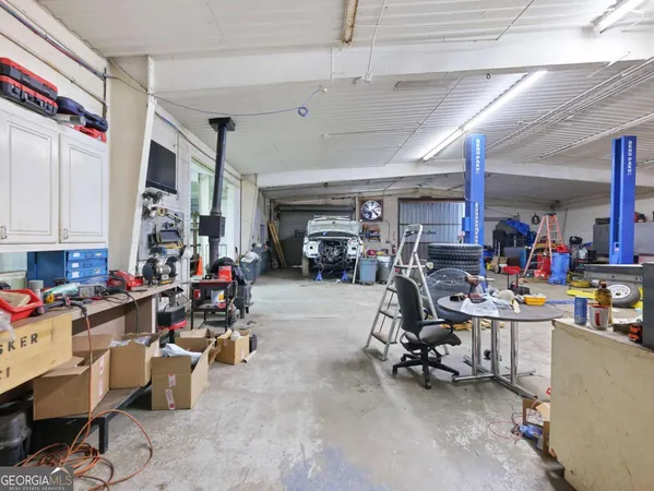 a view of a patio with table and chairs under an umbrella