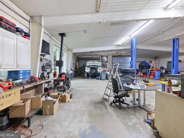 a view of a patio with table and chairs under an umbrella