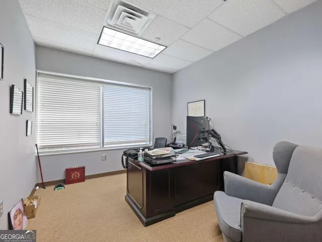 a living room with furniture and a lamp