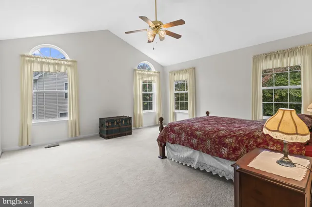 a spacious bedroom with a bed and a window