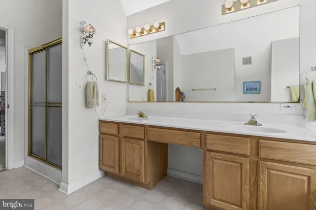 a bathroom with a double vanity sink and mirror