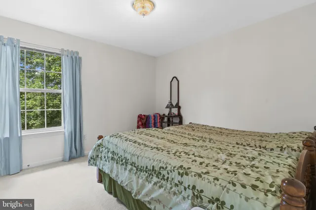 a bed sitting in a bedroom next to a window