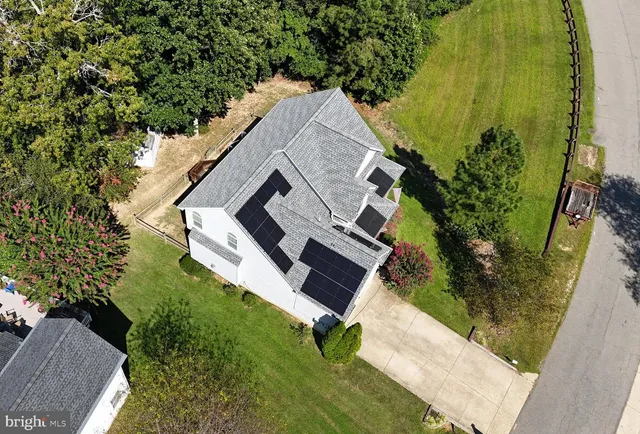 an aerial view of a house with a yard