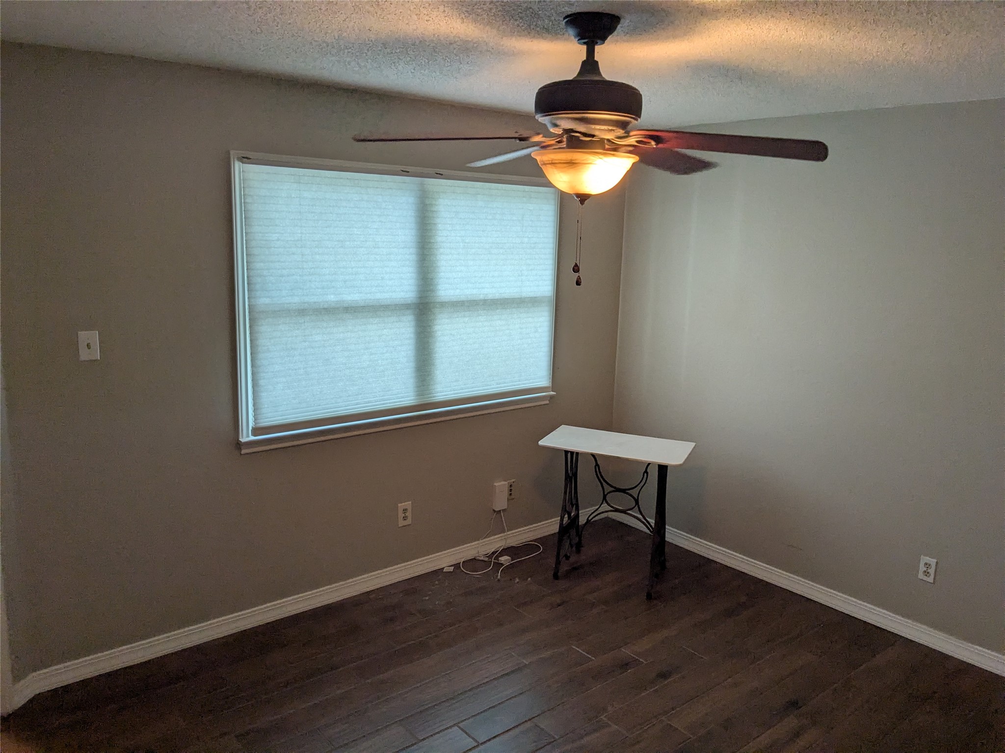 2502 Charla Circle Austin, TX 78728 - Photo 5 of 14 A well-proportioned room featuring rich hardwood flooring and a functional ceiling fan with lighting.