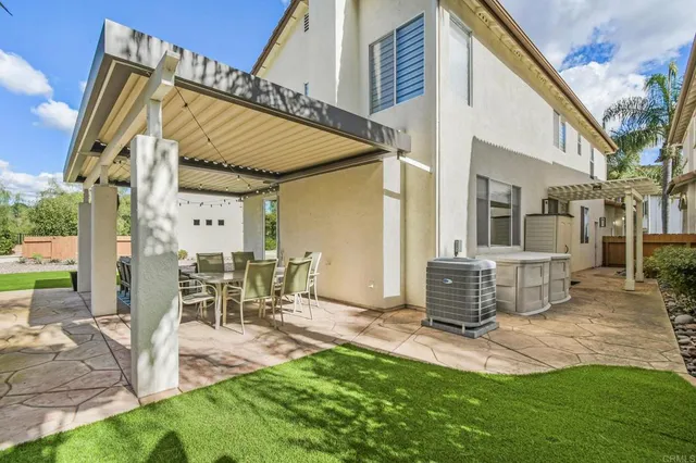 a view of a patio with table and chairs with wooden floor and fence