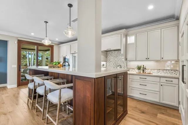 a kitchen with granite countertop white cabinets and stainless steel appliances