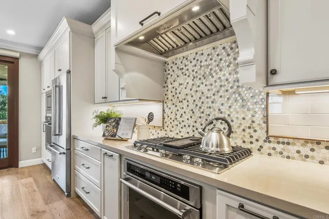a kitchen with granite countertop a sink and a stove