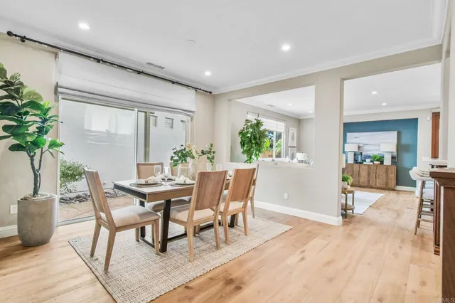 a dining room with furniture and wooden floor