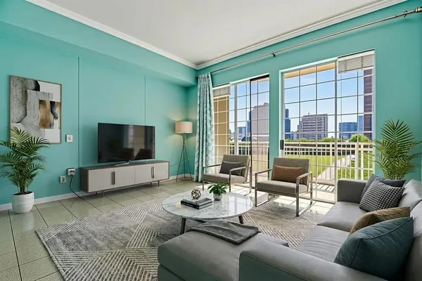 a living room with furniture and a flat screen tv