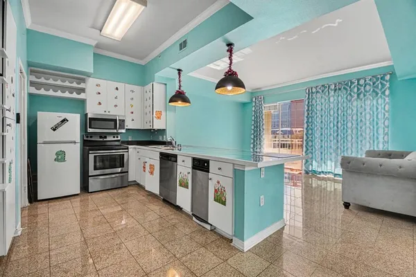 a kitchen with stainless steel appliances a stove a sink and a refrigerator