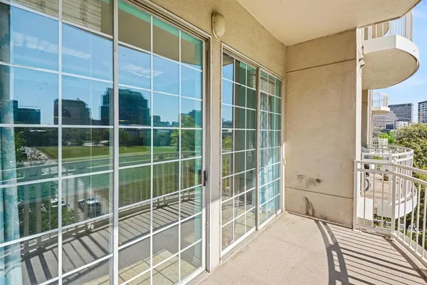 a view of a balcony with a floor to ceiling window and wooden floor