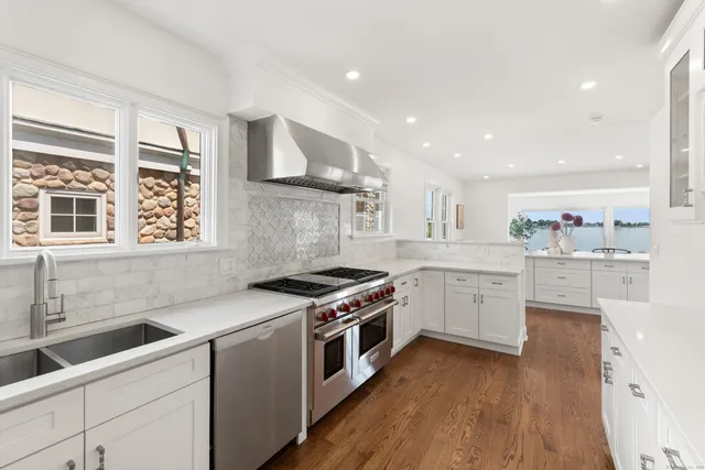 a kitchen with a stove top oven sink and cabinets