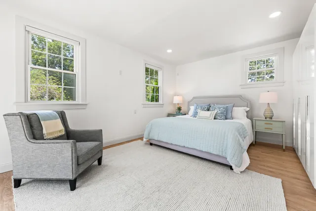 a bedroom with a bed and glass window