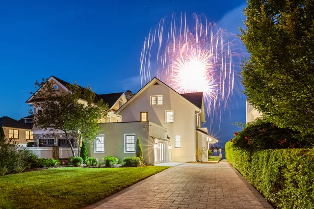 a front view of a house with a garden and yard