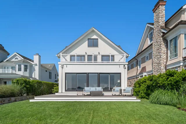 a front view of a house with a yard table and chairs