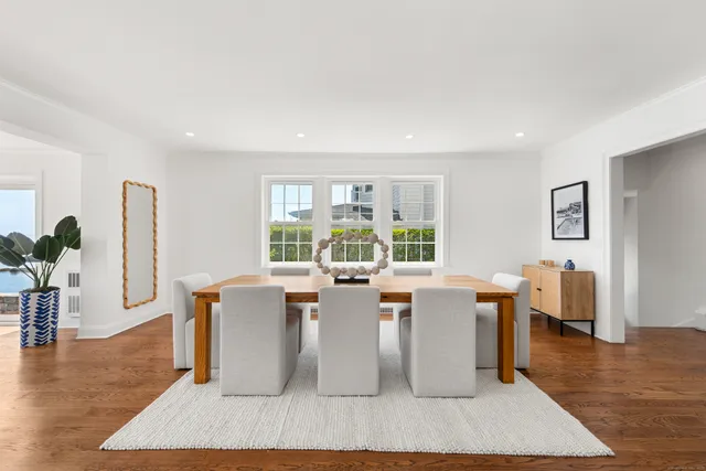 a living room with furniture wooden floor and a large window