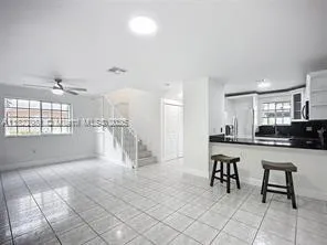 a view of a livingroom with furniture and a kitchen