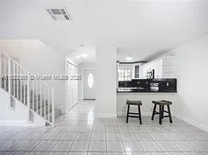 a kitchen with stainless steel appliances a sink and cabinets