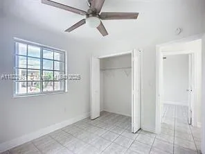 a view of a kitchen with a sink and a refrigerator