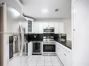 a kitchen with stainless steel appliances a stove sink and refrigerator