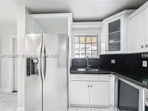 a kitchen with a refrigerator and a sink