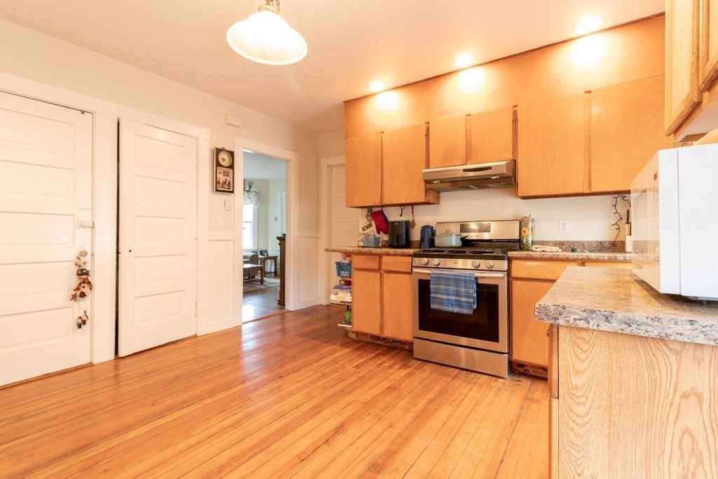 14 Dunlap Street Salem, MA 01970 - Photo 12 of 28 a kitchen with stainless steel appliances granite countertop a stove a sink and a refrigerator