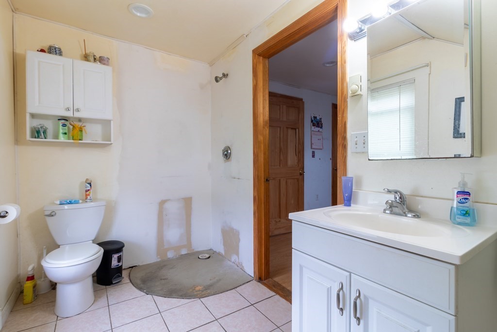 14 Dunlap Street Salem, MA 01970 - Photo 19 of 28 a bathroom with a toilet sink and mirror