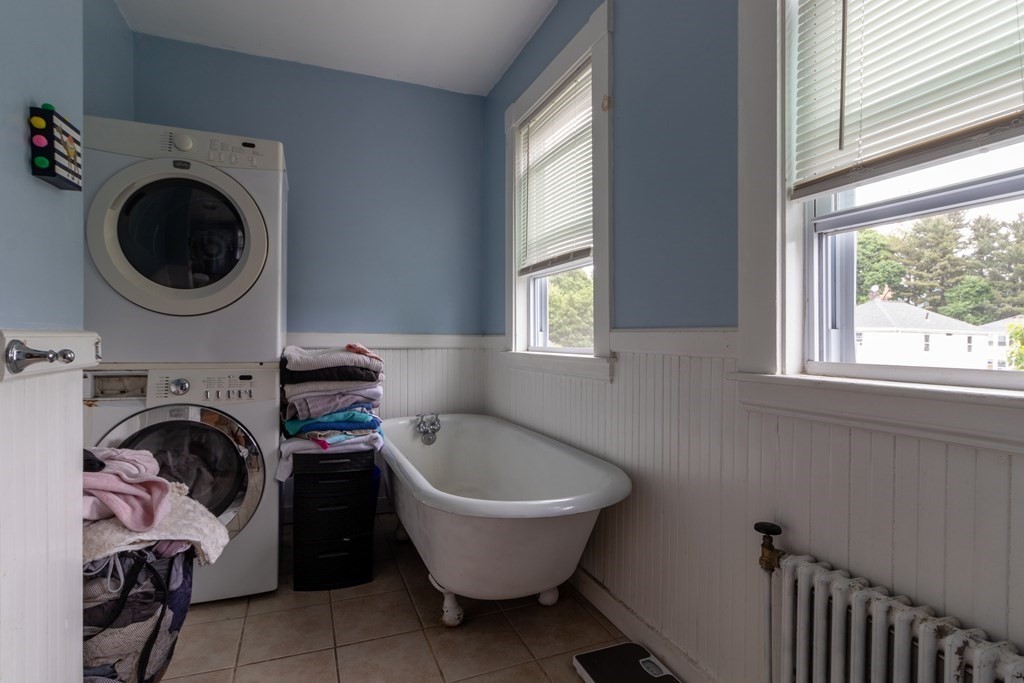 14 Dunlap Street Salem, MA 01970 - Photo 20 of 28 a bathroom with a sink a washer and dryer next to a window
