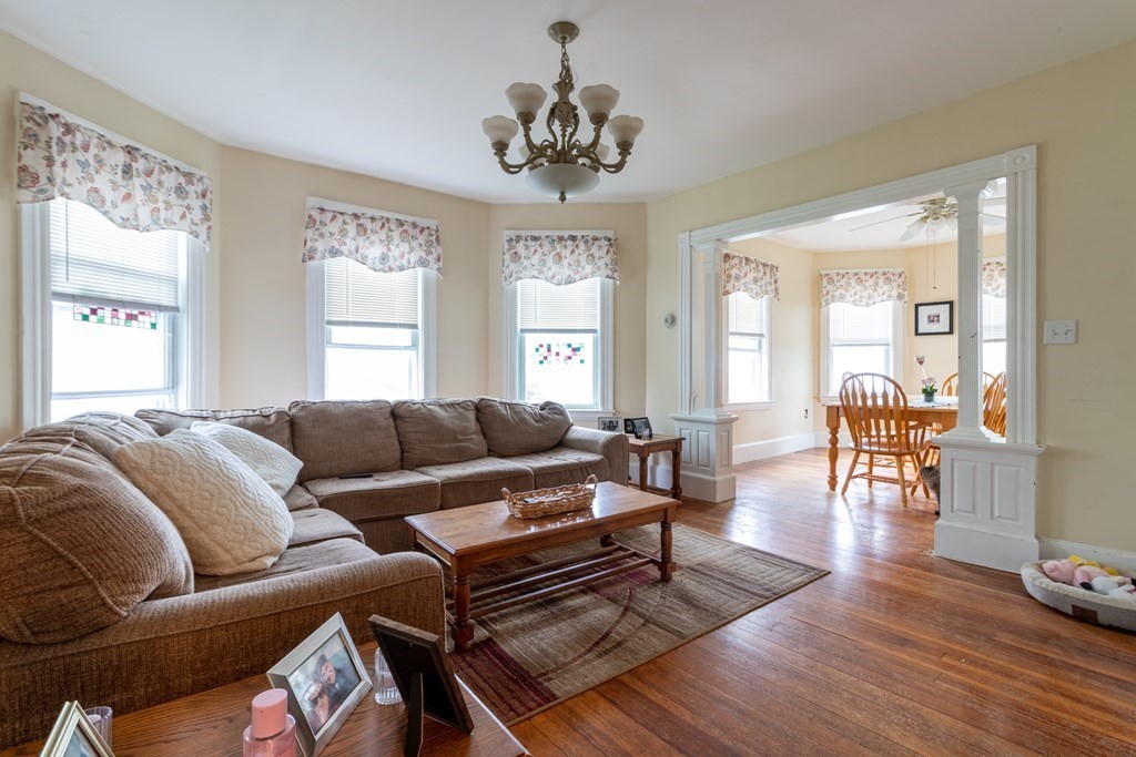 14 Dunlap Street Salem, MA 01970 - Photo 9 of 28 a living room with furniture a window and a chandelier