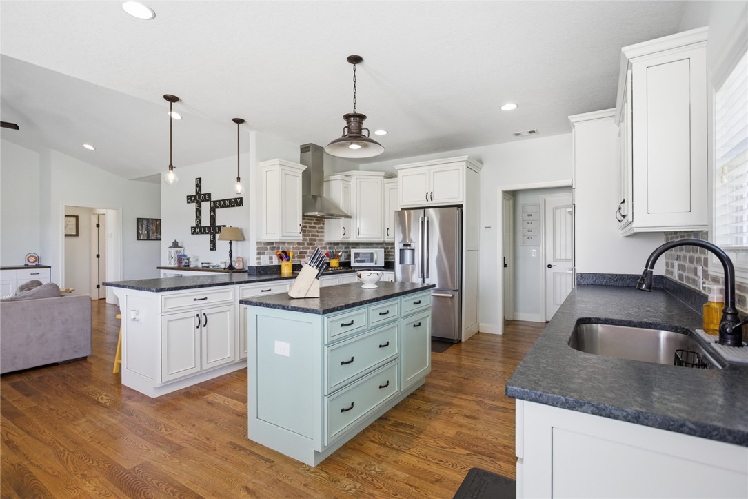 426 Oak Creek Road Seneca, SC 29678 - Photo 11 of 50 This kitchen features a central island, recessed lighting, and hardwood flooring.