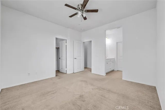 a view of an empty room with a ceiling fan