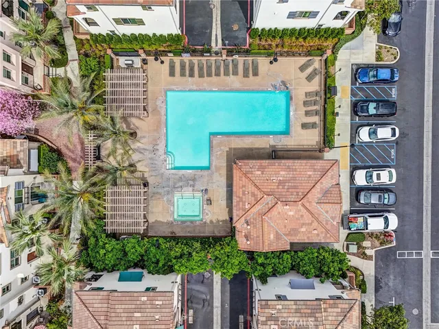 an aerial view of multiple houses with a yard