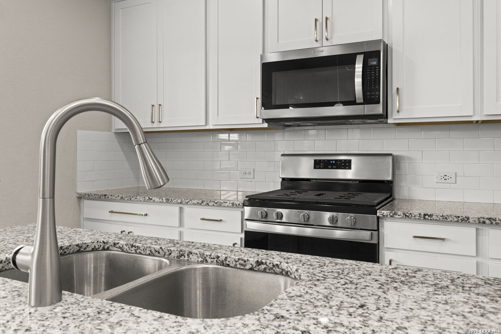 12221 Icon Ridge San Antonio, TX 78253 - Photo 14 of 46 a kitchen with stainless steel appliances granite countertop a sink a stove and microwave