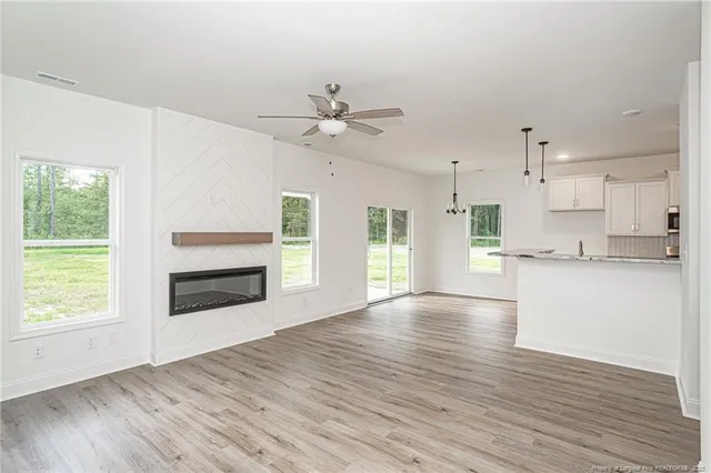 a view of a kitchen with wooden floor and a kitchen