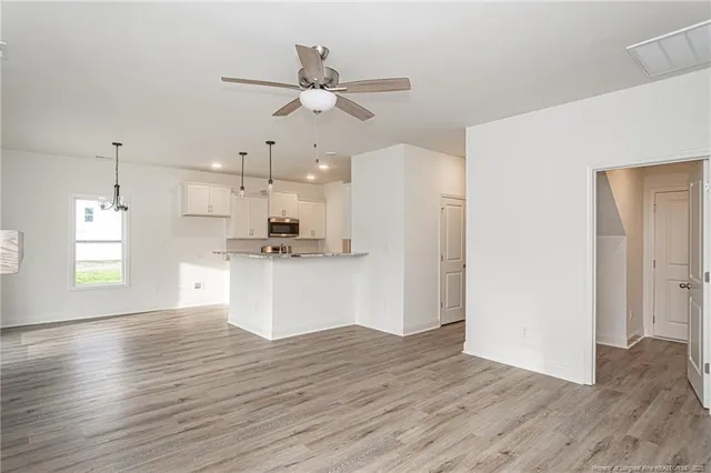 a view of a kitchen with a refrigerator and window