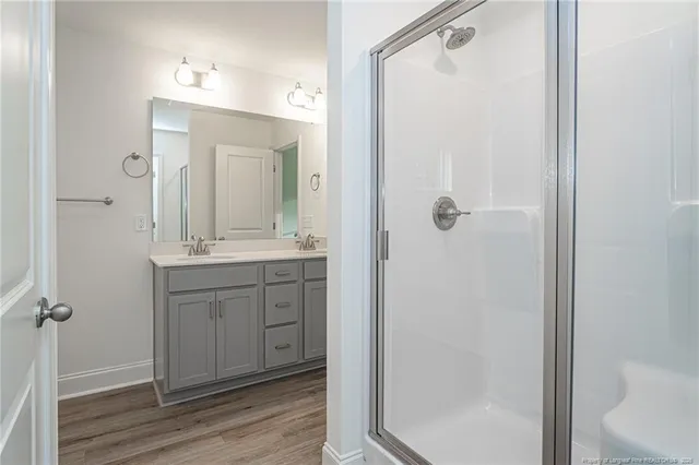 a bathroom with a shower sink and mirror