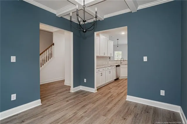 a view of a kitchen with a sink and wooden floor
