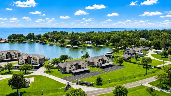 an aerial view of a house with outdoor space and lake view