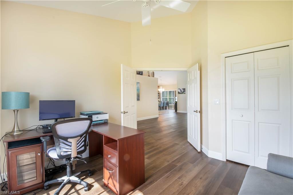 457 Raven Way Naples, FL 34110 - Photo 20 of 35 a living room with furniture and a wooden floor