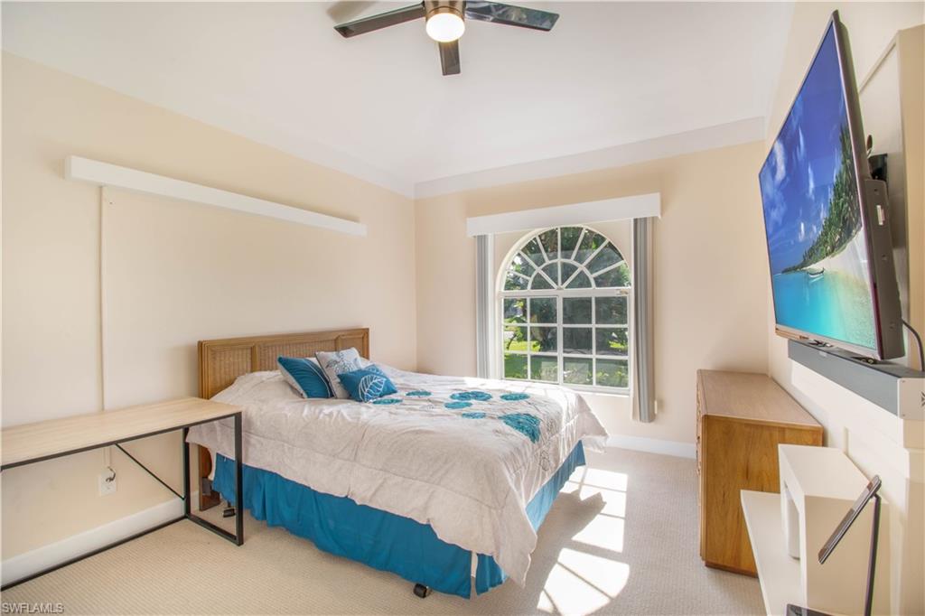 457 Raven Way Naples, FL 34110 - Photo 31 of 35 a bedroom with a bed and a large window