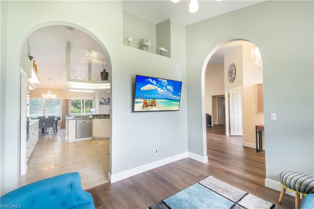 457 Raven Way Naples, FL 34110 - Photo 8 of 35 a view of a living room with wooden floor