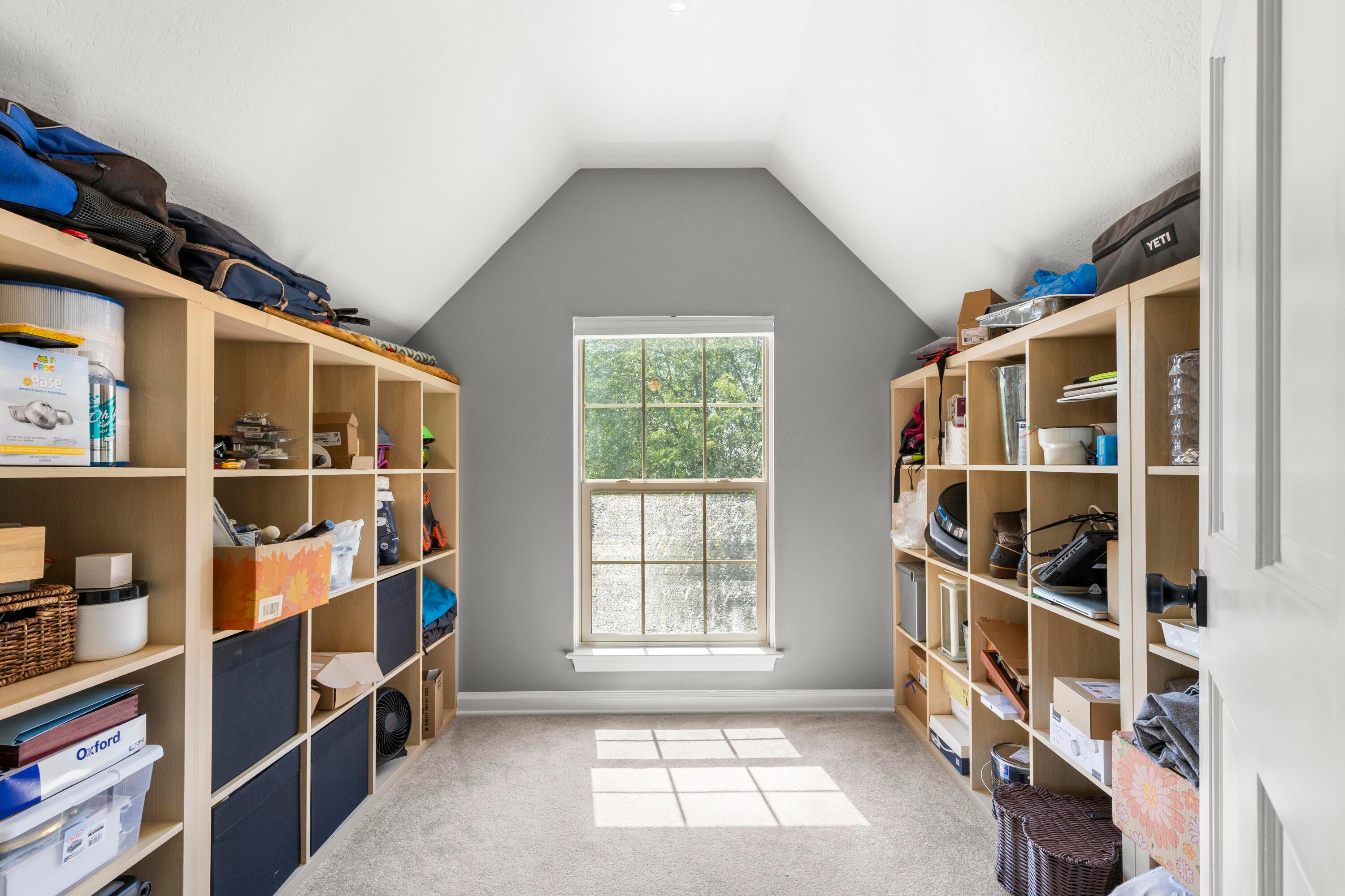 1515 Dale Ford Road Delaware, OH 43015 - Photo 40 of 74 • Light sand carpet • Grey painted walls • 3 bulb ceiling light • Shelves remain • Shades remain